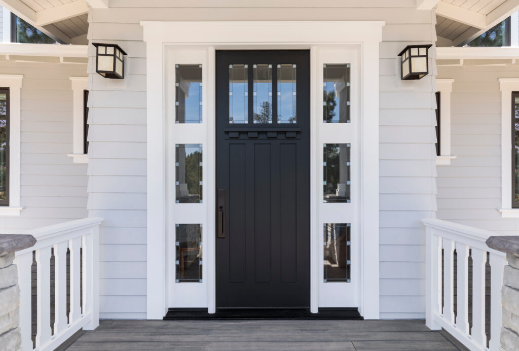 Picture of a front door entrance with black door and windows on sides