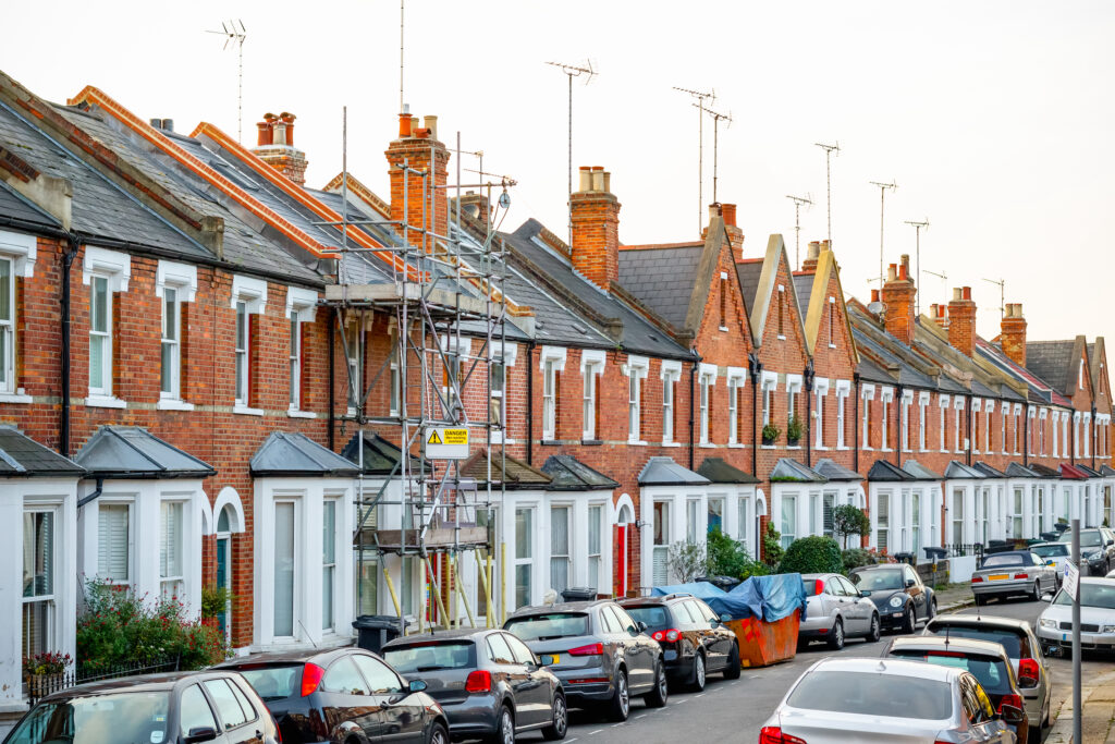 Picture of a row of houses one covered in scaffolding