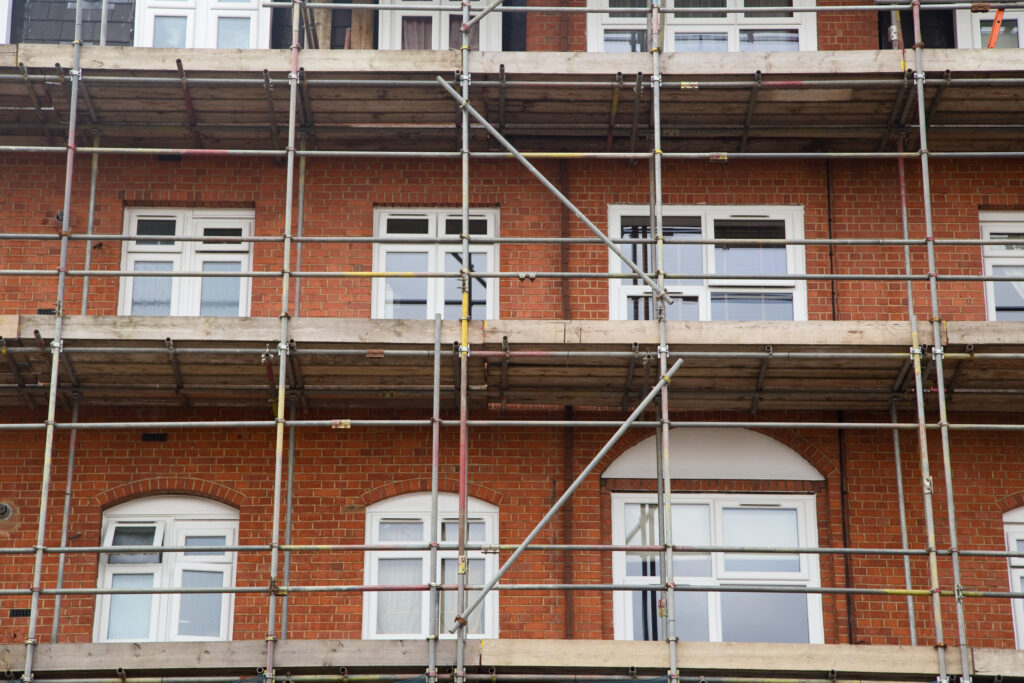 Picture of a house with scaffolding on across three storeys